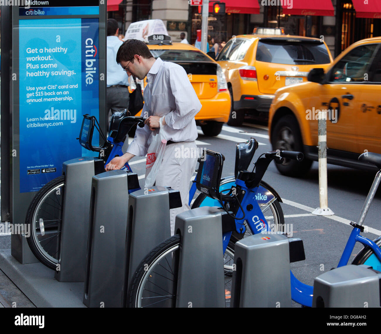 Man renting a Citibike rental bicycle in New York, NY, USA Stock Photo