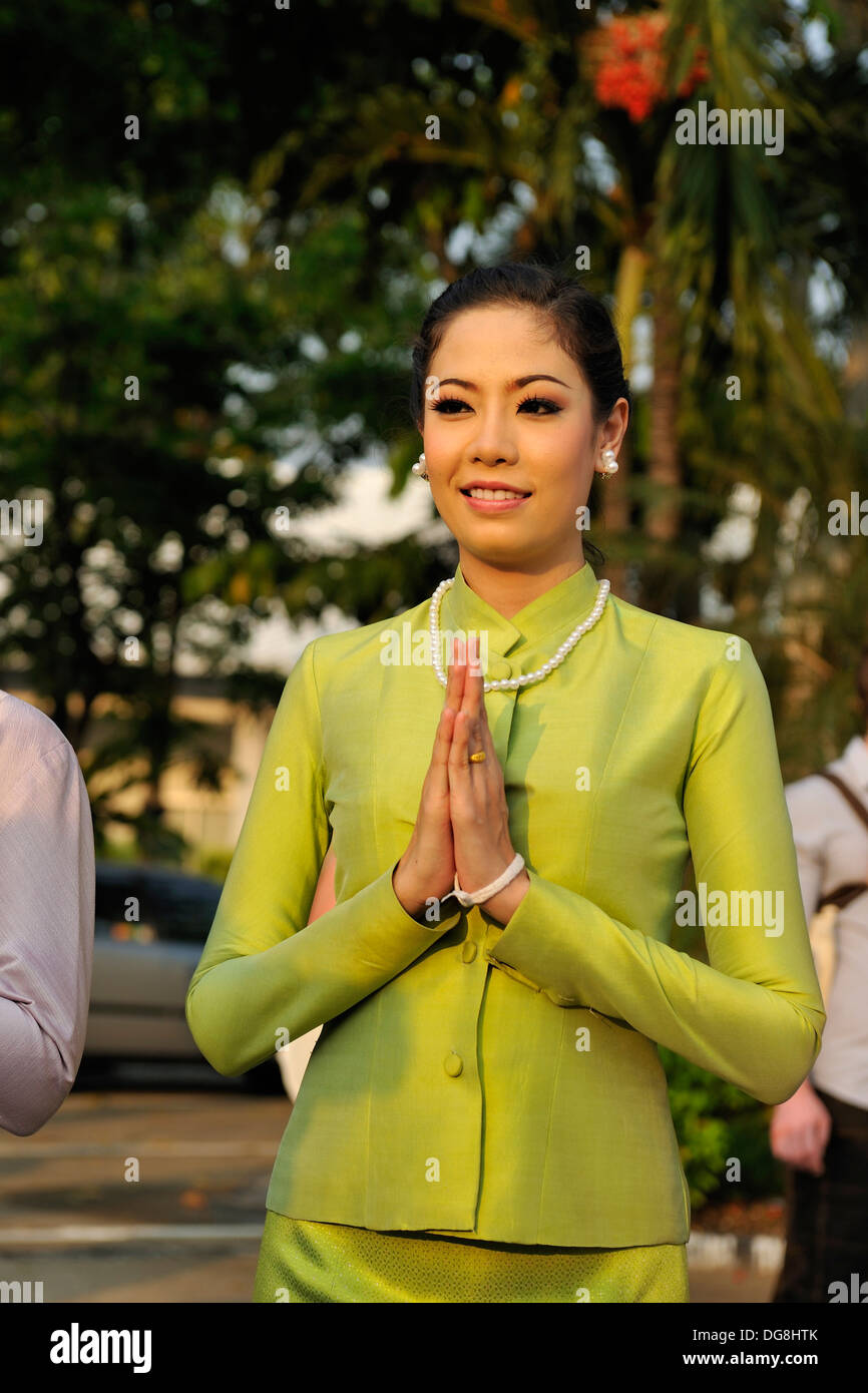 young pretty woman greeting in the Thai manner: the wai. Bangkok, Thailand, Asia Stock Photo