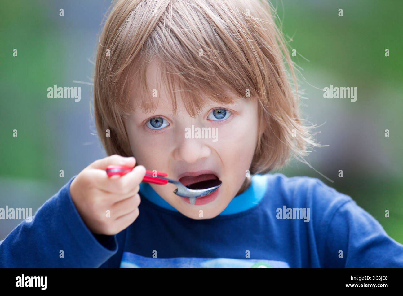 Boy with Blond Hair Eating Soup Stock Photo