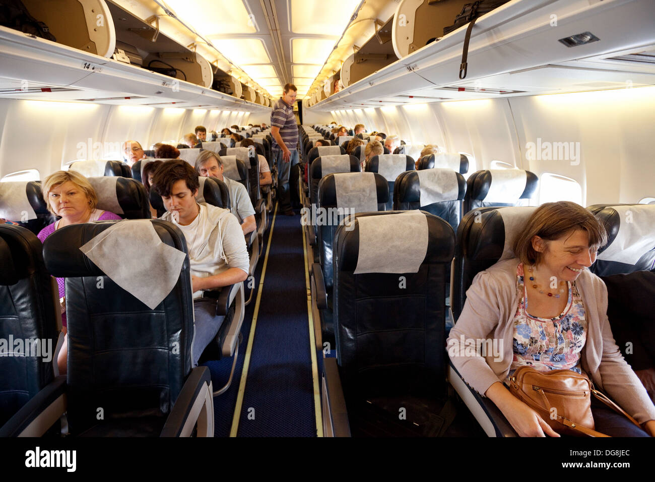 Passengers sitting in the cabin of a British Airways BA Boeing 737 plane, Johannesburg airport, South Africa Stock Photo
