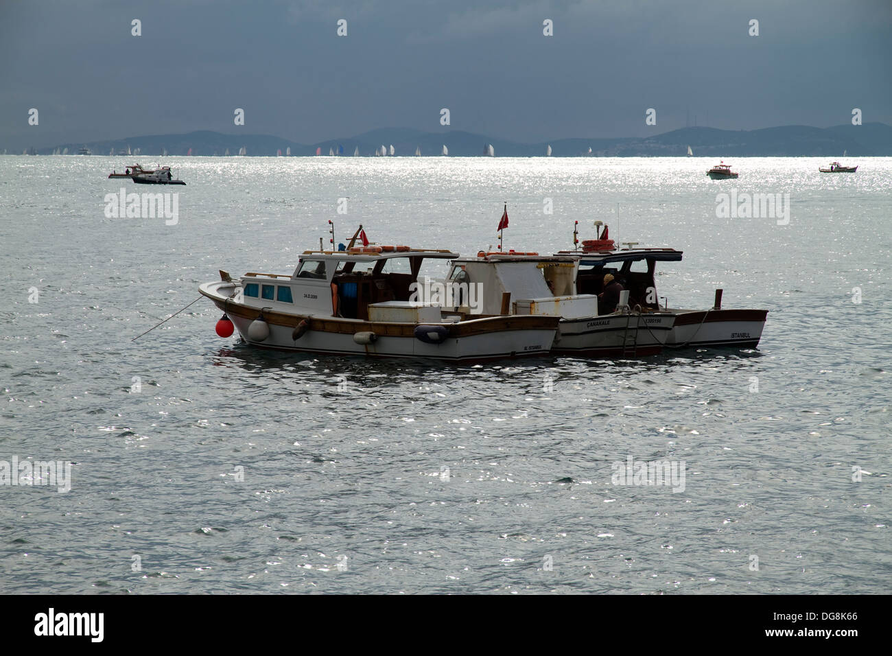 Local Fishing Boats Swaying on the Waves in Bosphorus Stock Photo