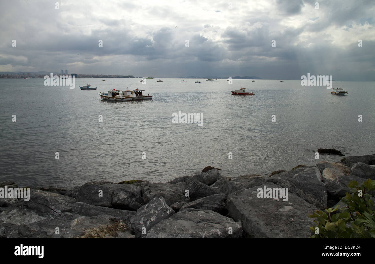 Local Fishing Boats Swaying on the Waves in Bosphorus Stock Photo