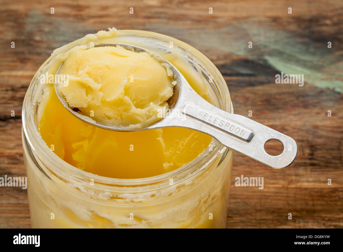 jar and measuring tablespoon of ghee clarified butter Stock Photo Alamy