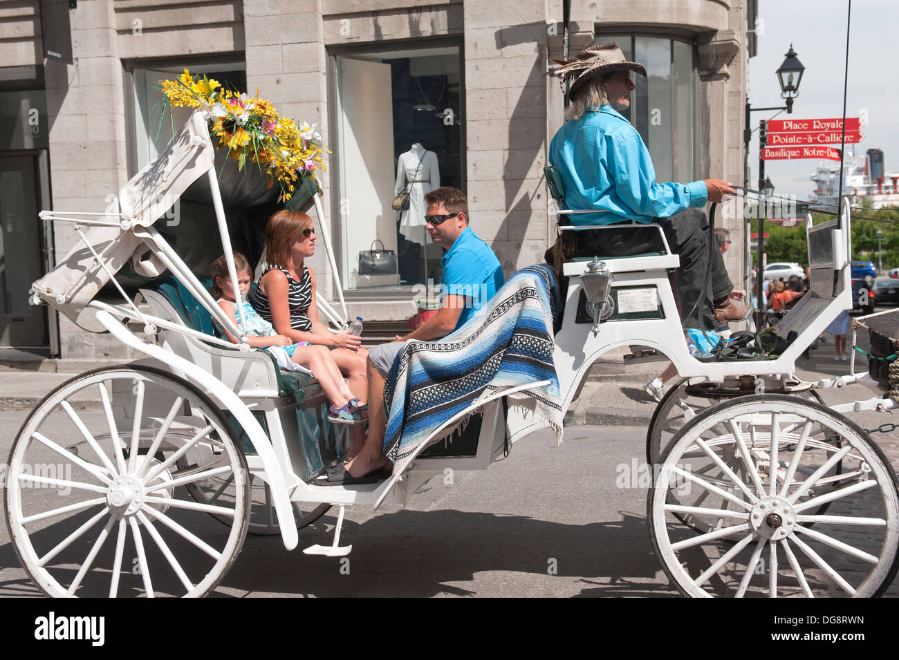 Family enjoying a horse drawn carriage ride in Old Montreal Stock Photo