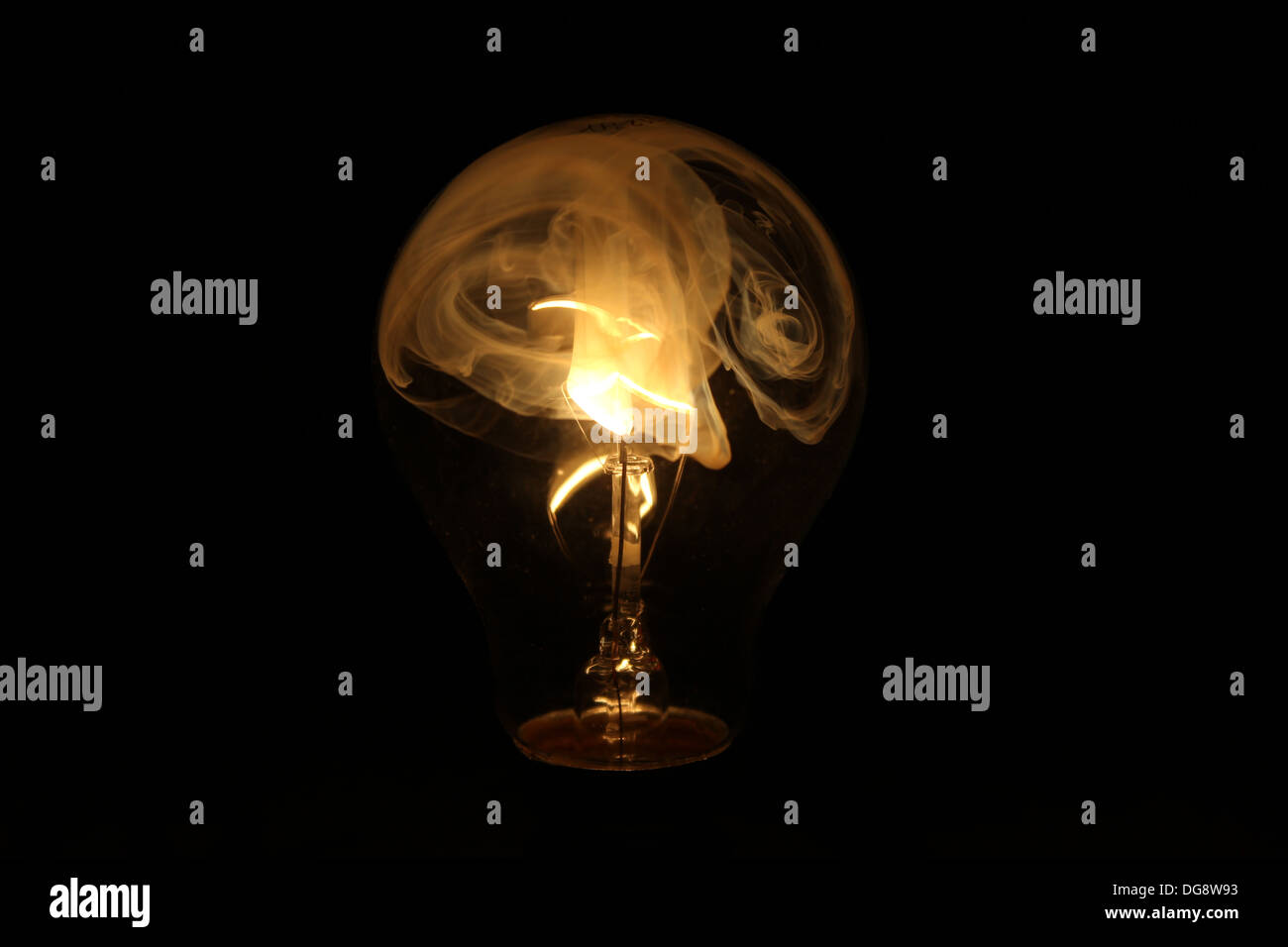 Broken Light bulb blown filament smoking. Image taken with the glass broken  on the bulb to allow the gas out and air in so letting the filament burn  Stock Photo - Alamy