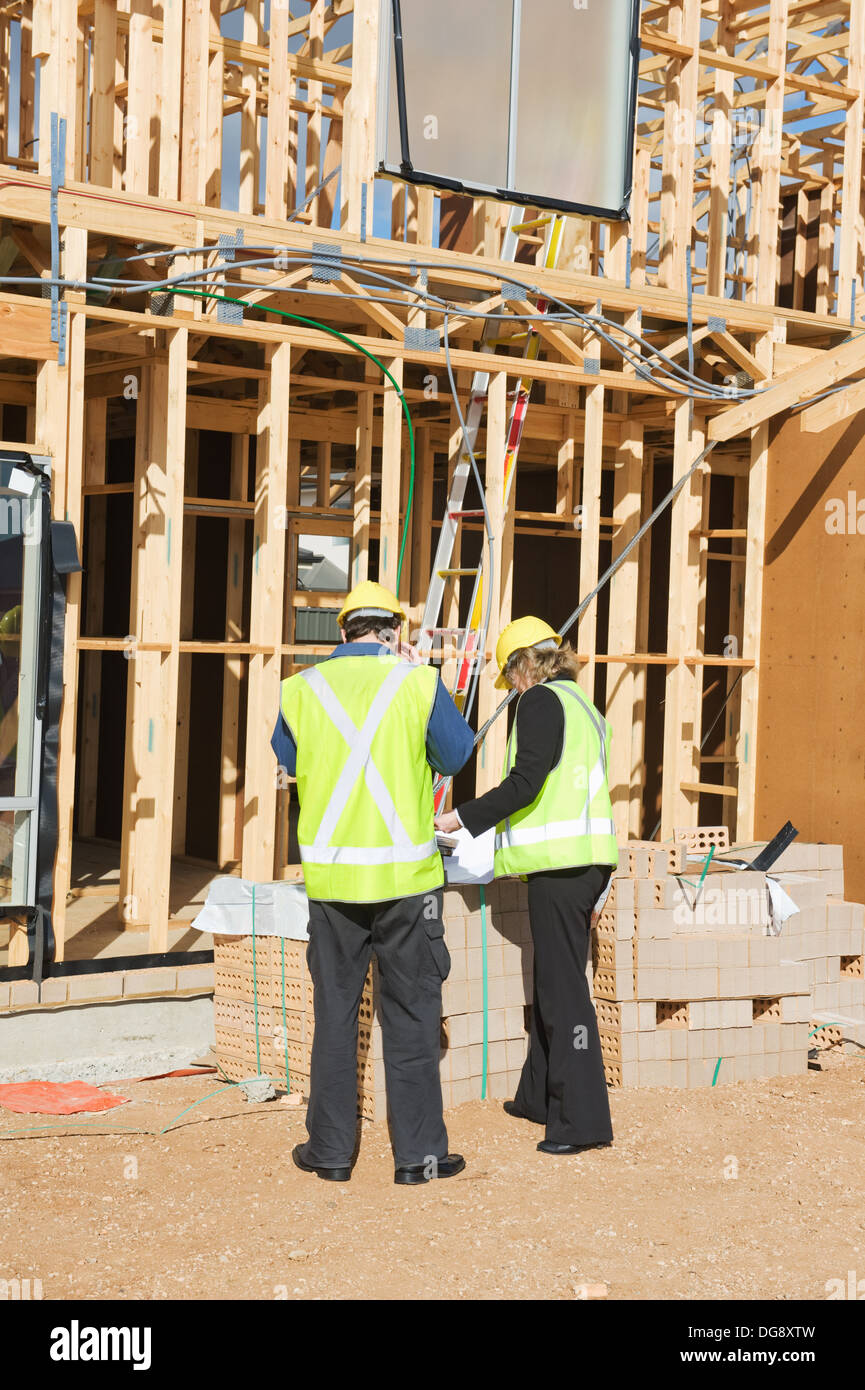 civil engineer and worker discussing issues at the construction site Stock Photo