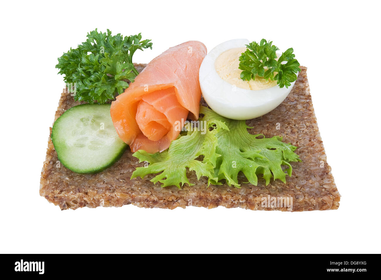 whole grain rye bread sandwich with salmon, egg and vegetables, isolated Stock Photo