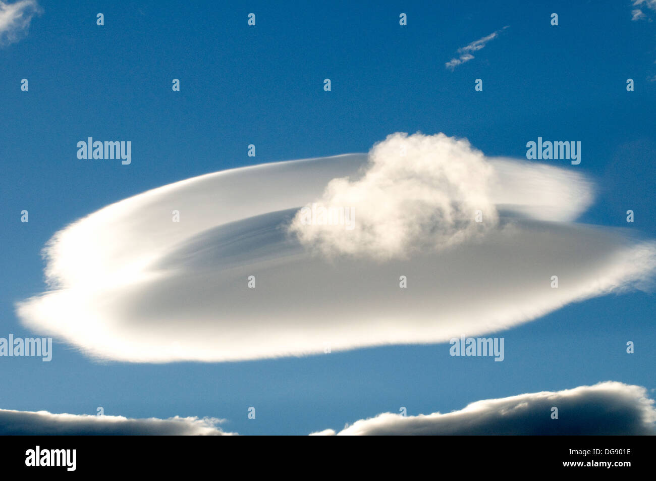 Altostratus Cloud Orgiva Alpuharas Granada Southern Spain radiant sunny blue morning sky UFO space ship like Stock Photo