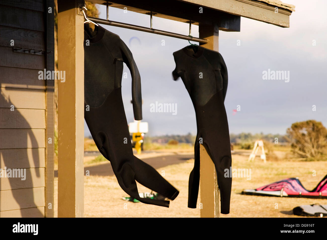 Kite surfers´ wet suits flailing in the wind at Crown Memorial State