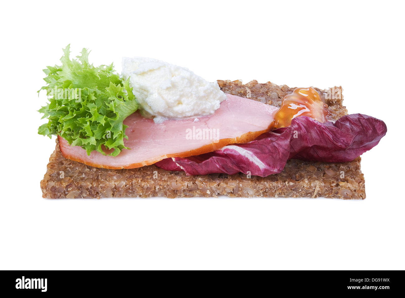whole grain rye bread sandwich with ham and vegetables isolated on white Stock Photo