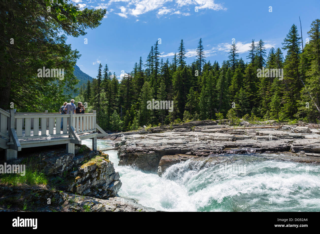 Tourists at McDonald Falls overlook, Glacier National Park, Montana ...
