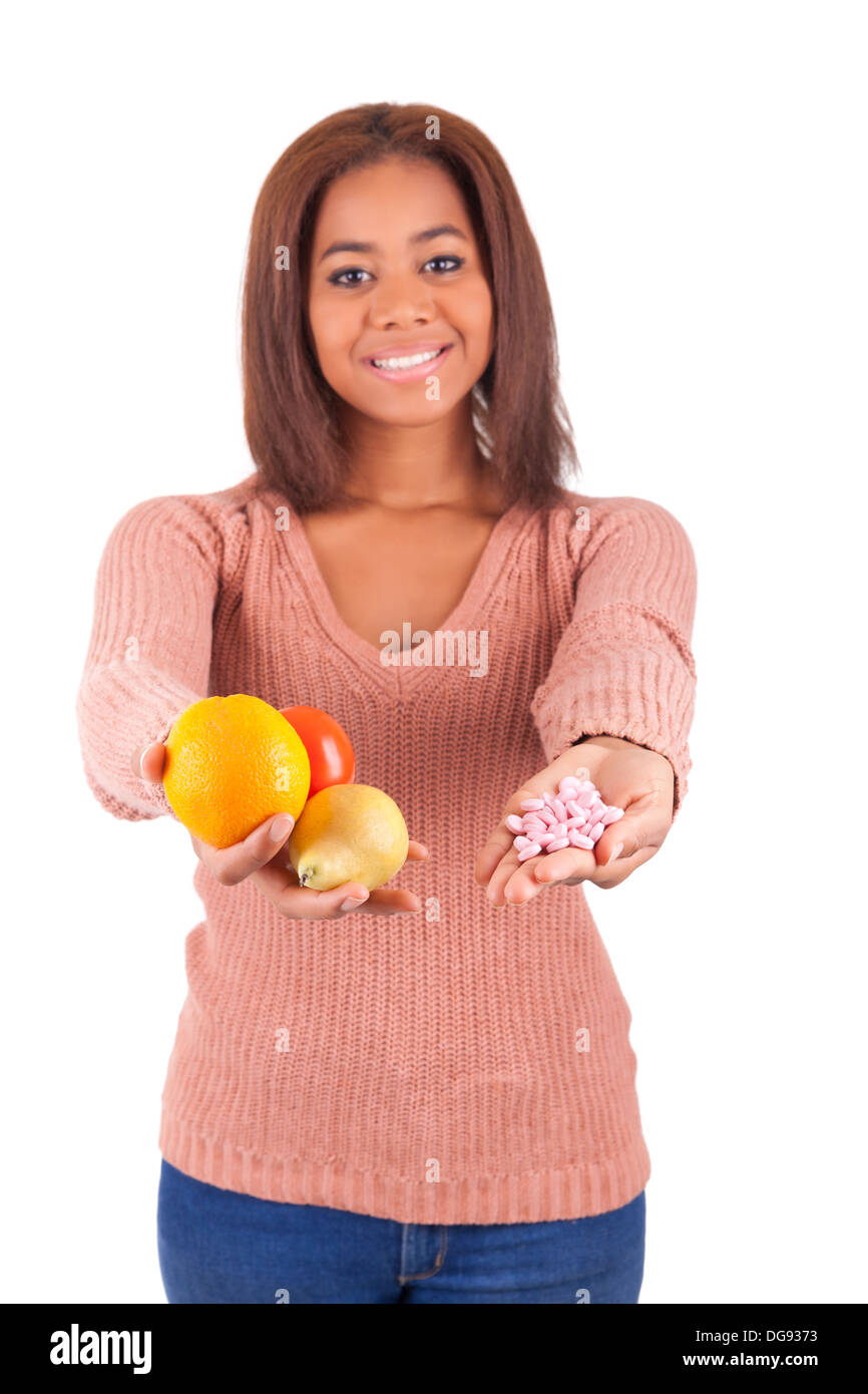 African woman and her choice - pills or fruit isolated Stock Photo