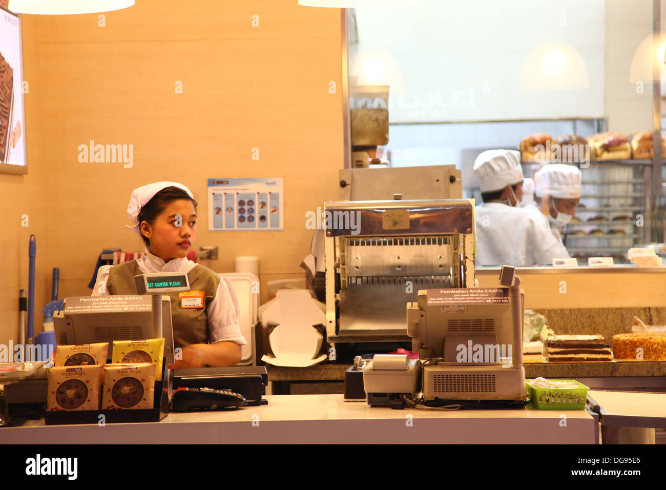 Cilandak Town Square, Jakarta, Indonesia - October 12, 2013: A female cashier on her post at BreadTalk Bakery in Cilandak Town S Stock Photo