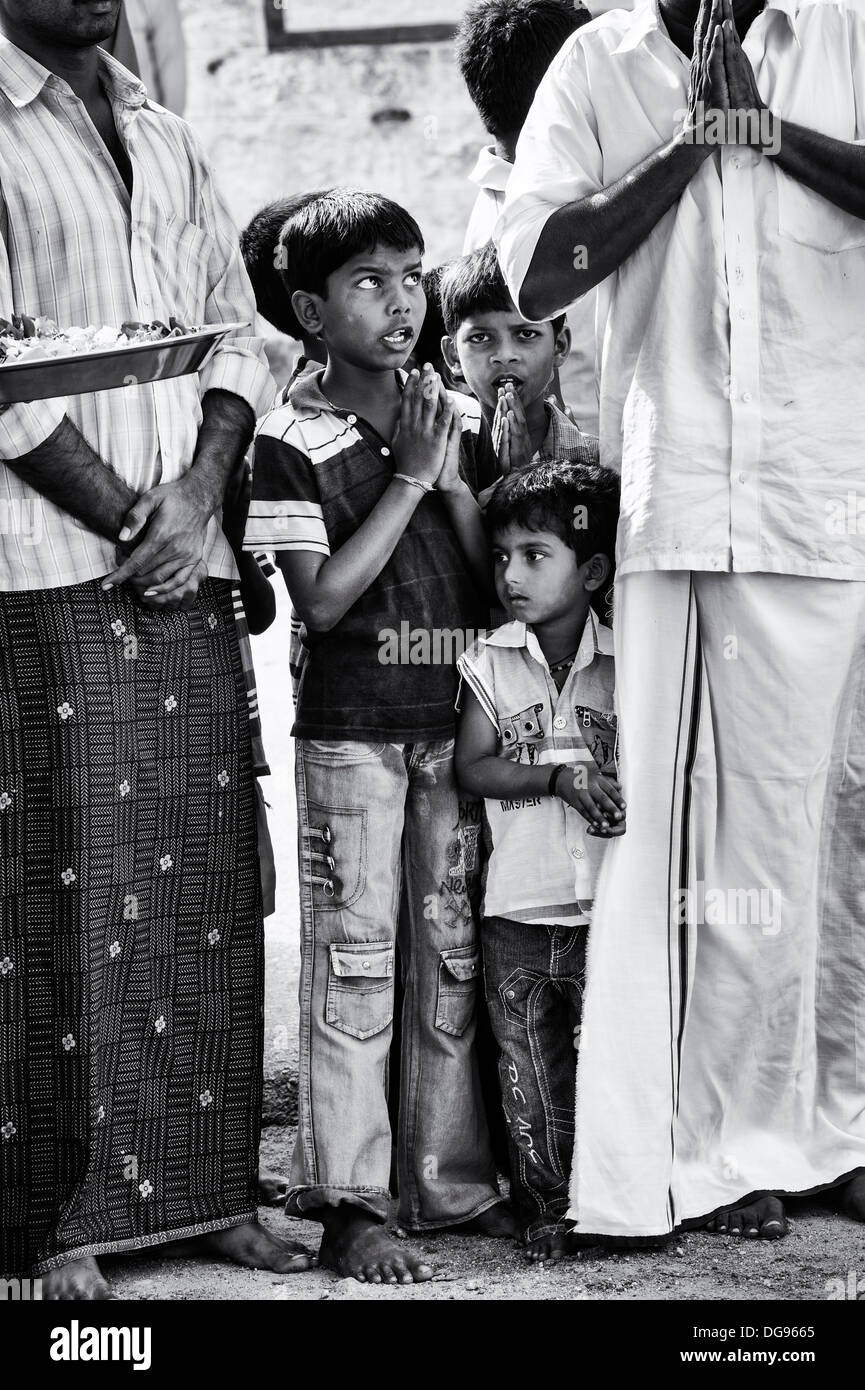 Rural Indian boys and men sing devotional songs at Sri Sathya Sai Baba mobile outreach hospital service. Andhra Pradesh, India. Stock Photo