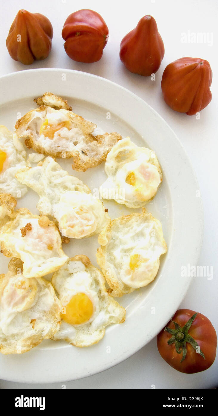 Fried quail eggs and tomatoes Stock Photo Alamy
