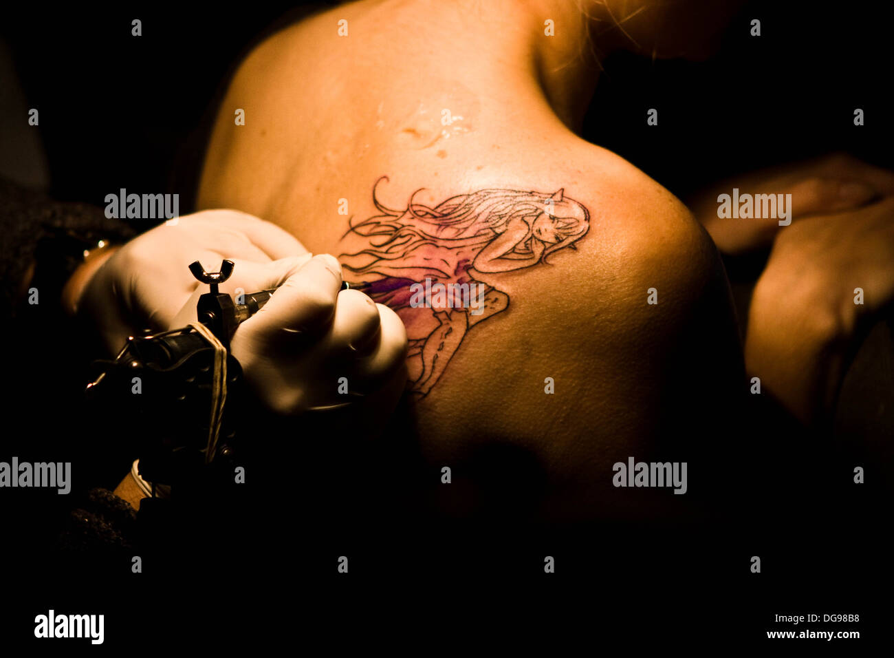 girl getting a tattoo Stock Photo