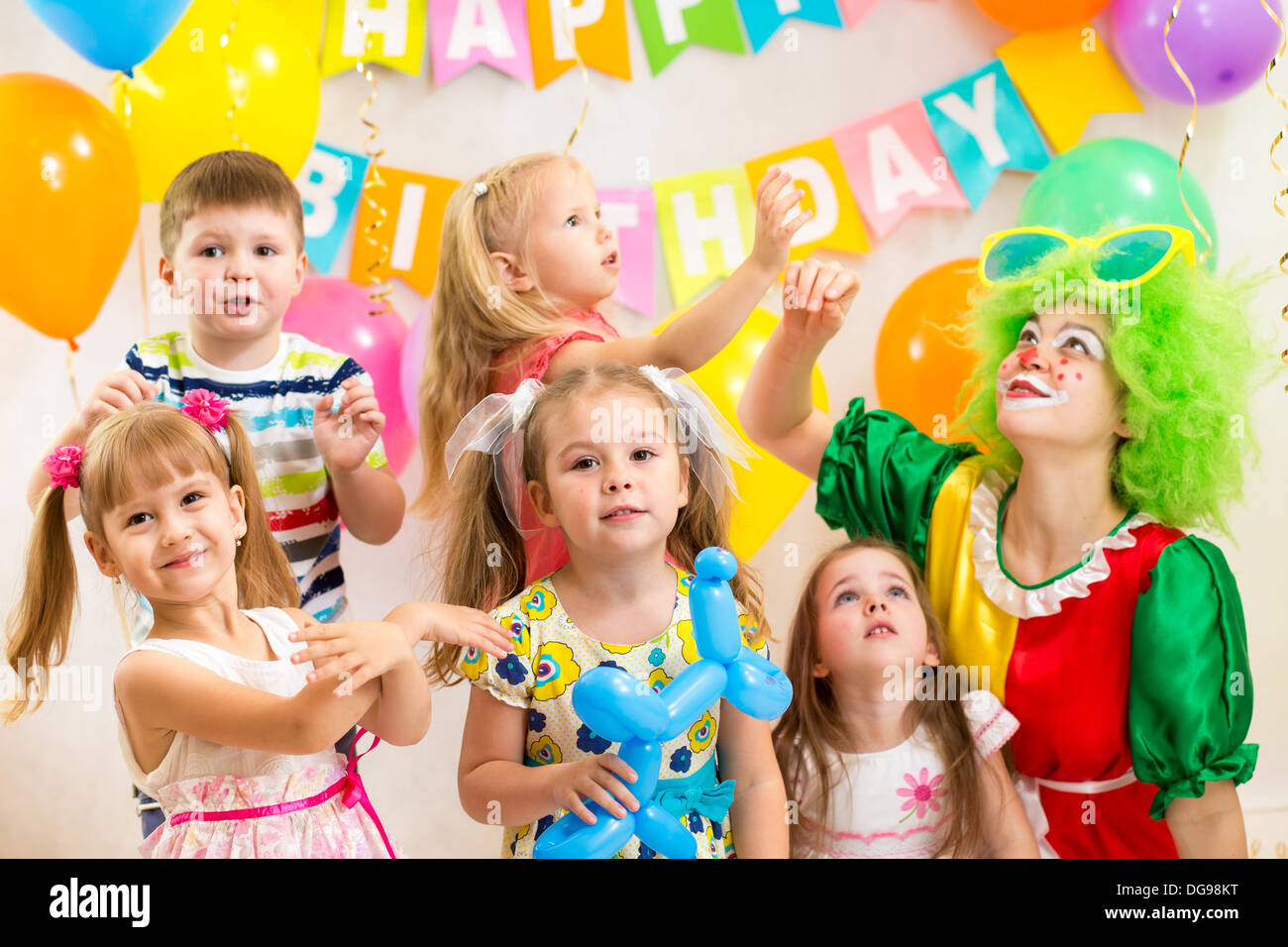 jolly kids group with clown celebrating birthday party Stock Photo
