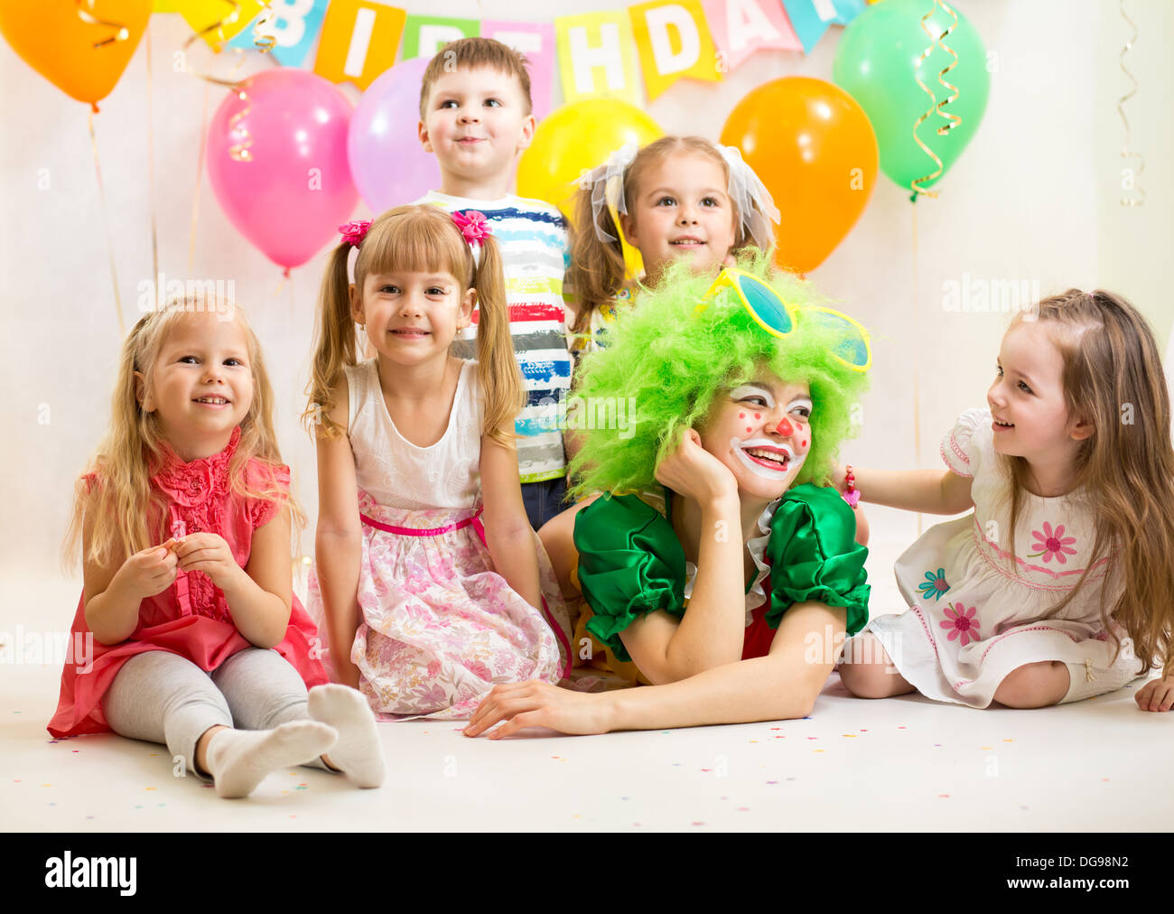 jolly kids group and clown on birthday party Stock Photo
