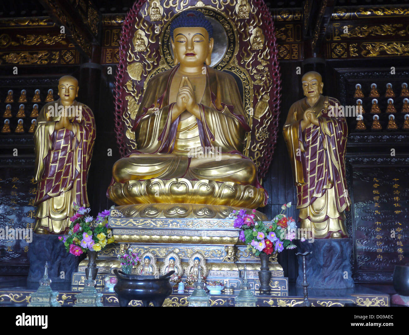 Golden Buddha and Disciples Sculpture in a Shrine, Big Wild Goose Pagoda, Xian, Shaanxi, China Stock Photo