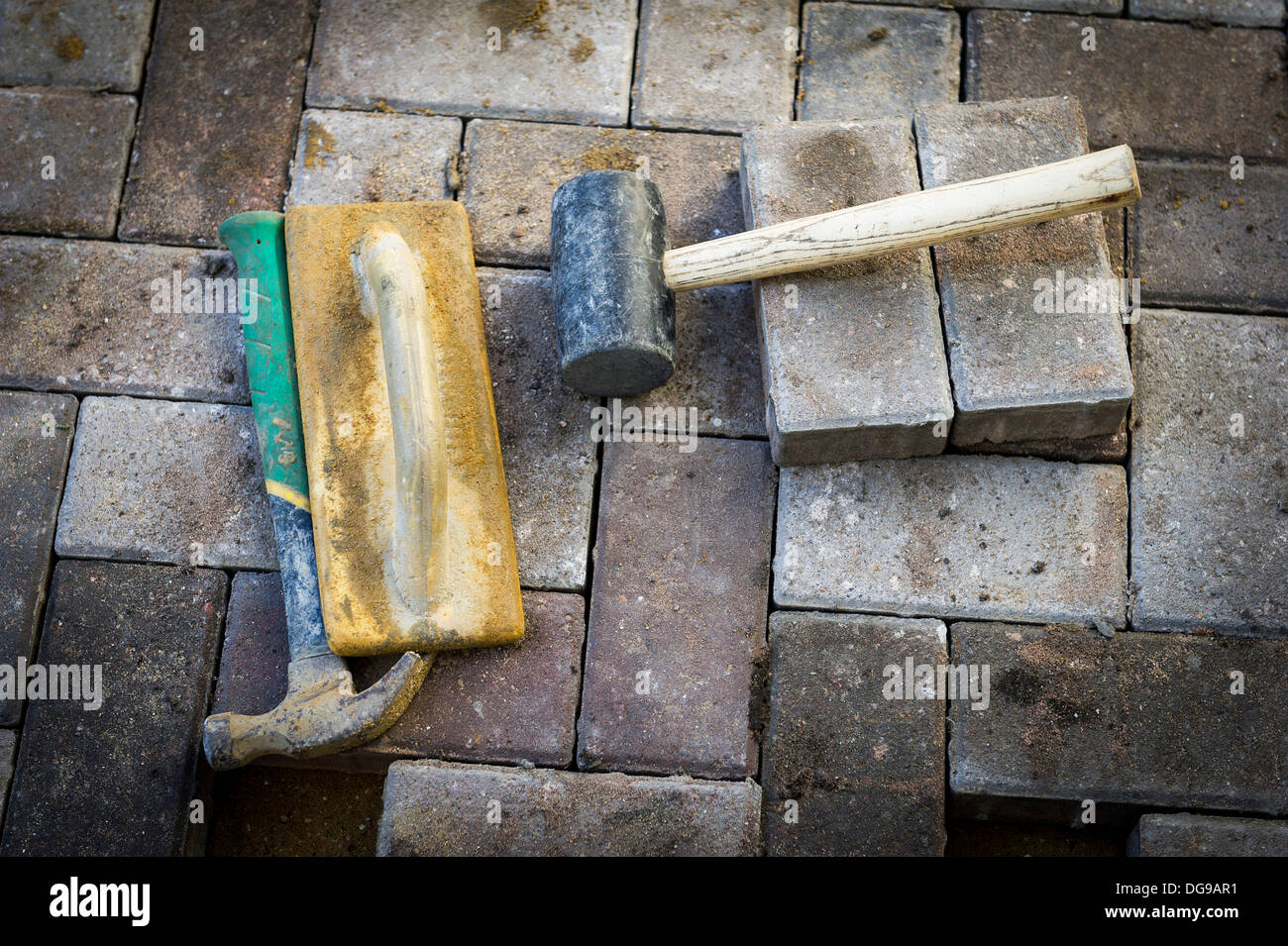 Tools used to lay a block paving pathway. Stock Photo