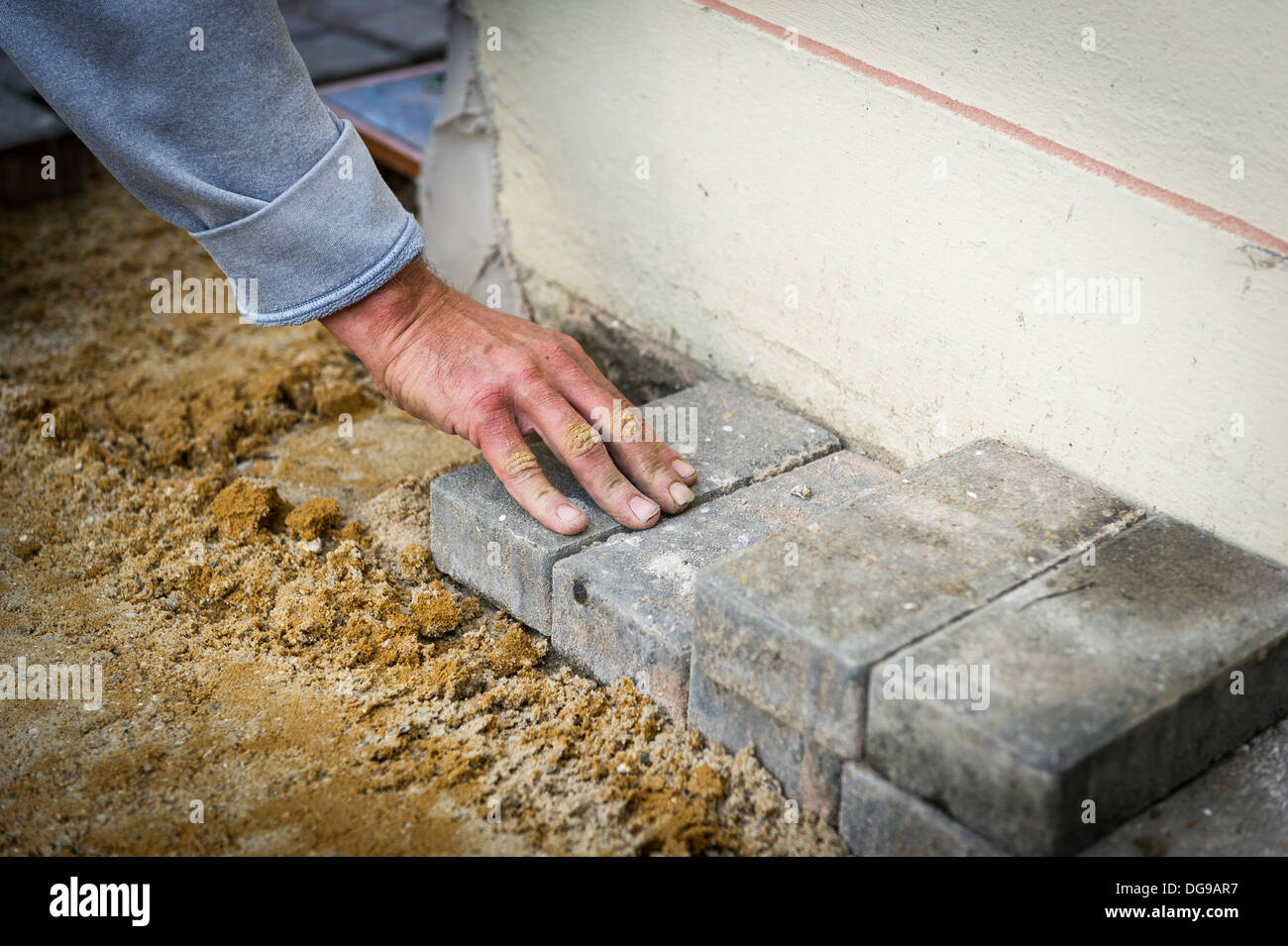 A block paver laying a block pathway Stock Photo Alamy
