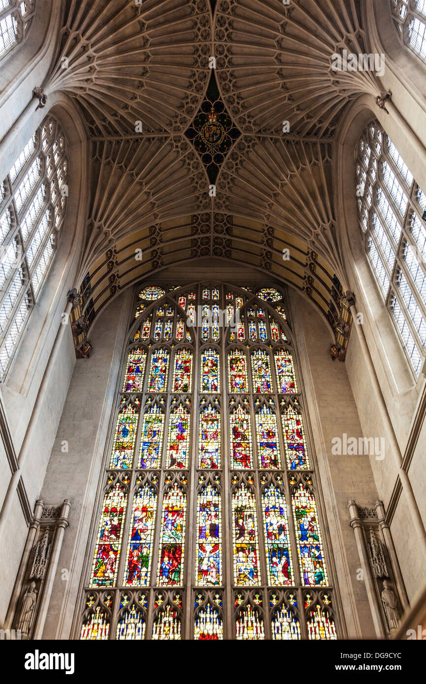 Interior of Bath Abbey showing the fan vaulting ceiling and stained glass window above the altar. Stock Photo