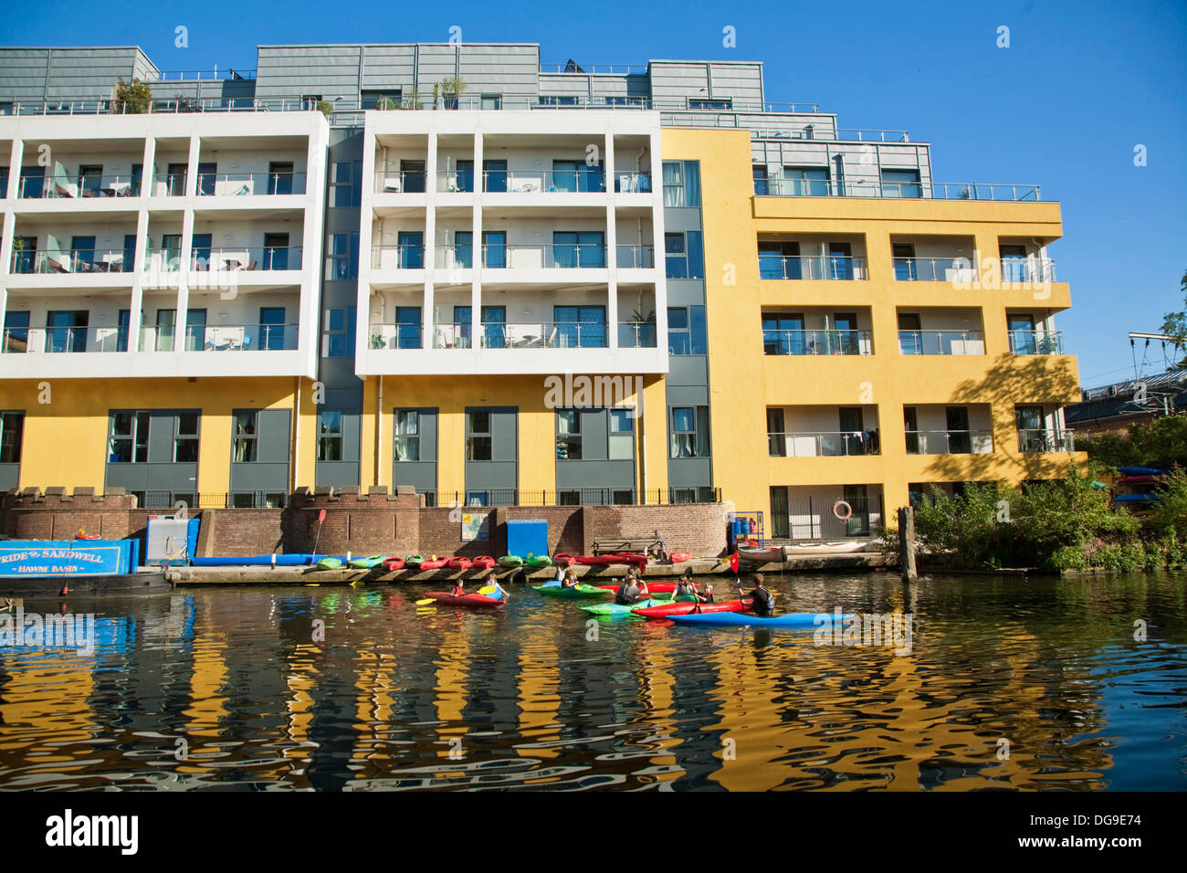 Children having canoe lesson in front of canal apartments, Regent´s Canal, Camden Lock, London