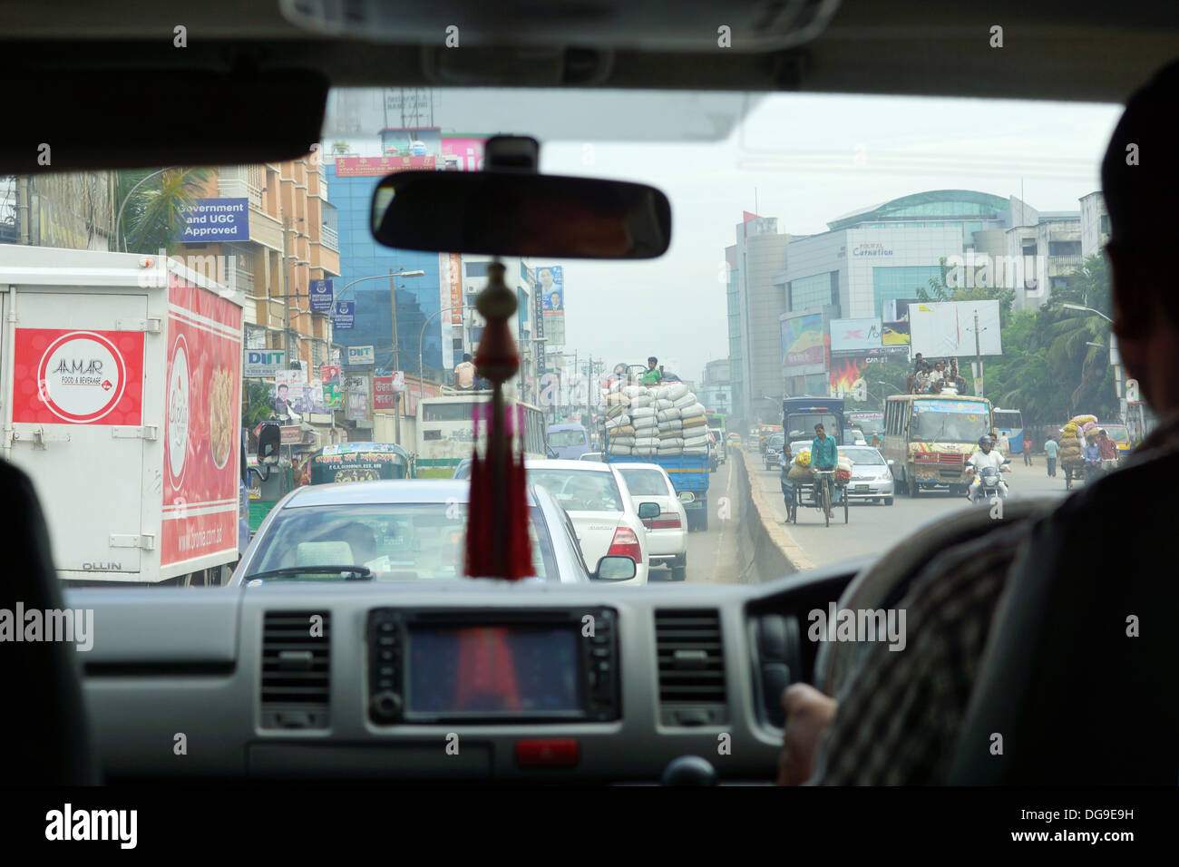 A busy street scene in early morning traffic in Dhaka Stock Photo