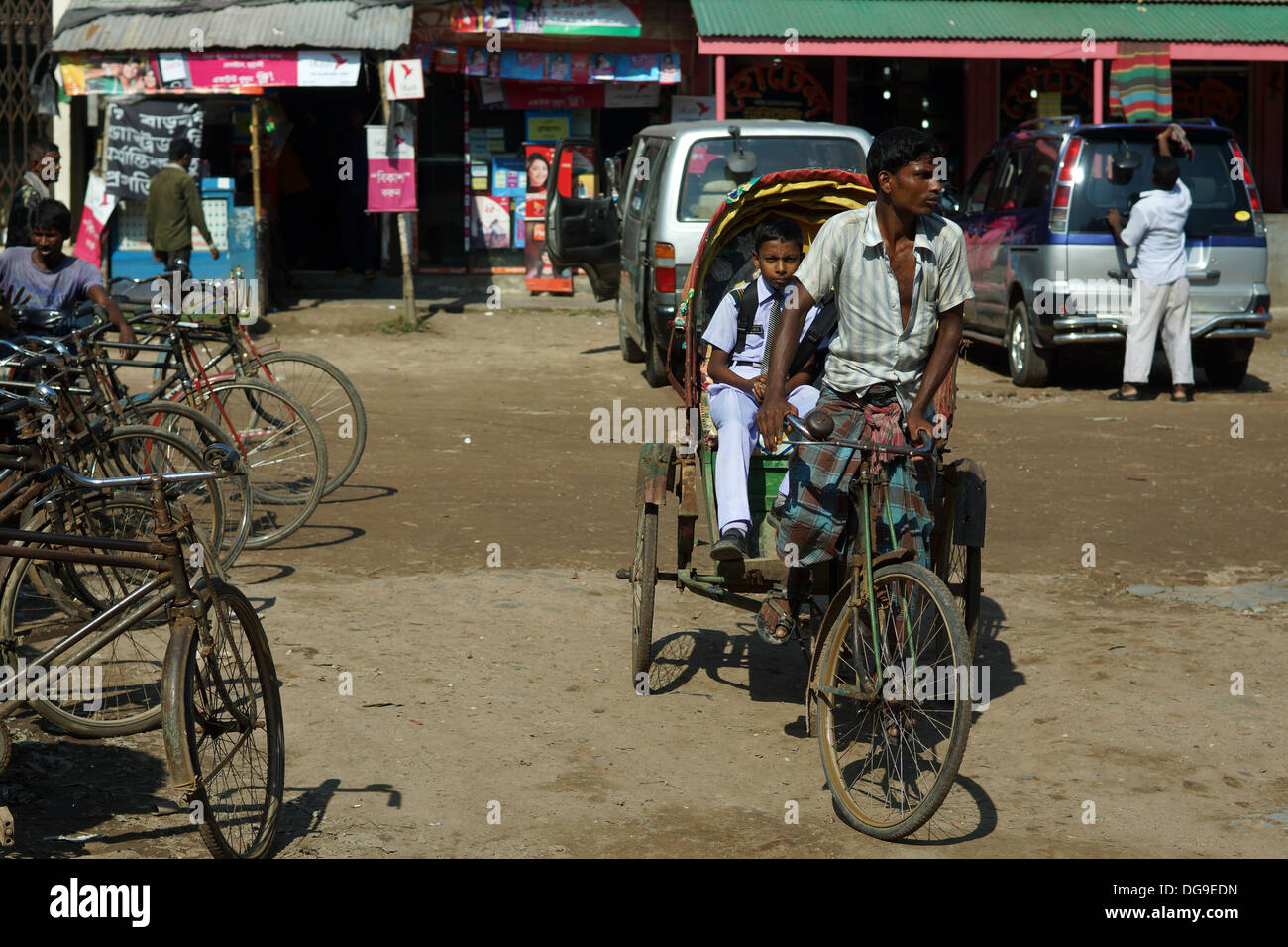 A young boy on a rickshaw on his way to school Stock Photo - Alamy