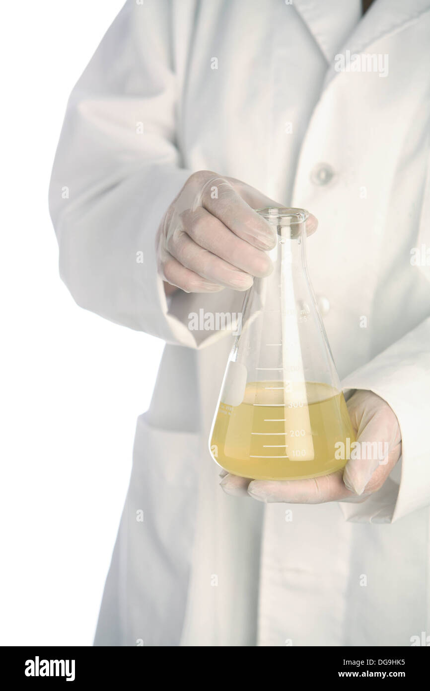 Person in lab coat holds beaker of liquid Stock Photo Alamy