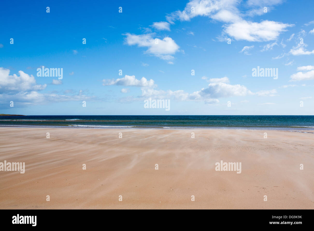 Sand blowing along the beach in windy conditions at Beadnell Bay, in Northumberland, UK. Stock Photo