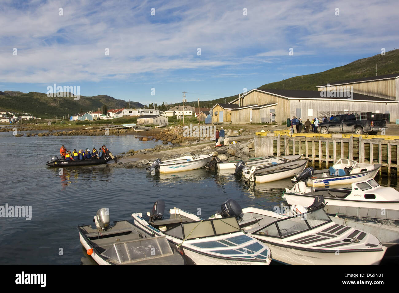Zodiac with tourists accosting a wharf of Nain, Labrador Zodiac with tourists accosting a wharf of Nain, Labrador