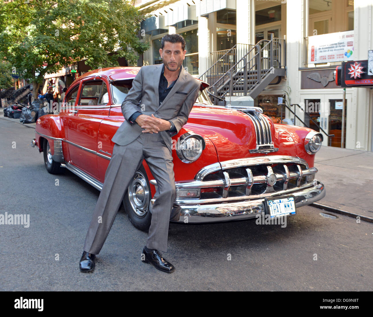 Portrait of former mixed martial arts champion Extreme LaCosta in front of his vintage 1950 Pontiac Silver Streak Stock Photo