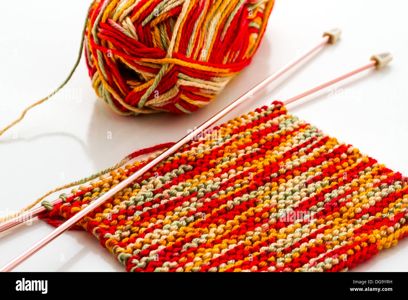 Knitting with multi colored yarn with orange, red, and yellow tones Stock  Photo - Alamy