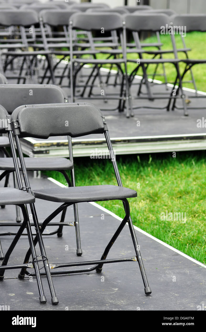 Rows of empty seats ready for outdoor wedding or concert. Stock Photo