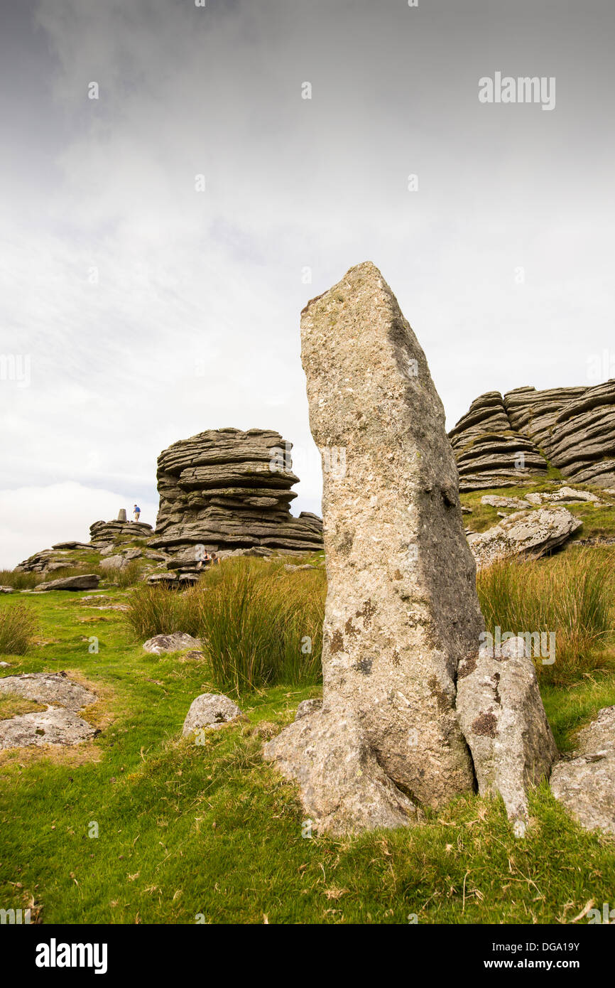 A granite Tor and standing stone on the summit of Great Links Tor, on Dartmoor, Devon, UK. Stock Photo