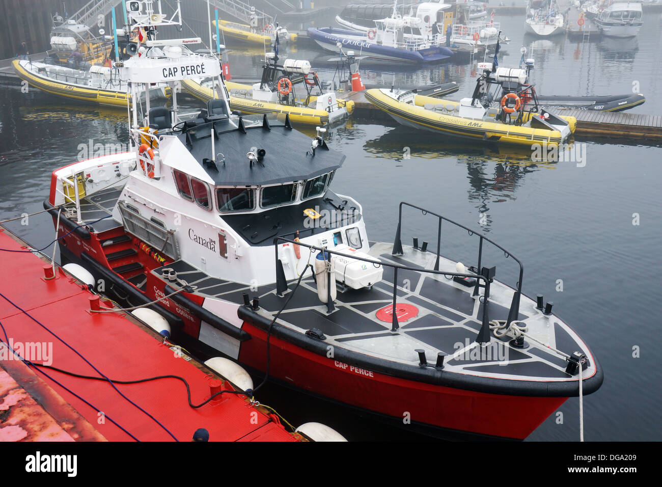 Canadian coast guard boat or Boston whaler docked in Tadoussac harbour Stock Photo