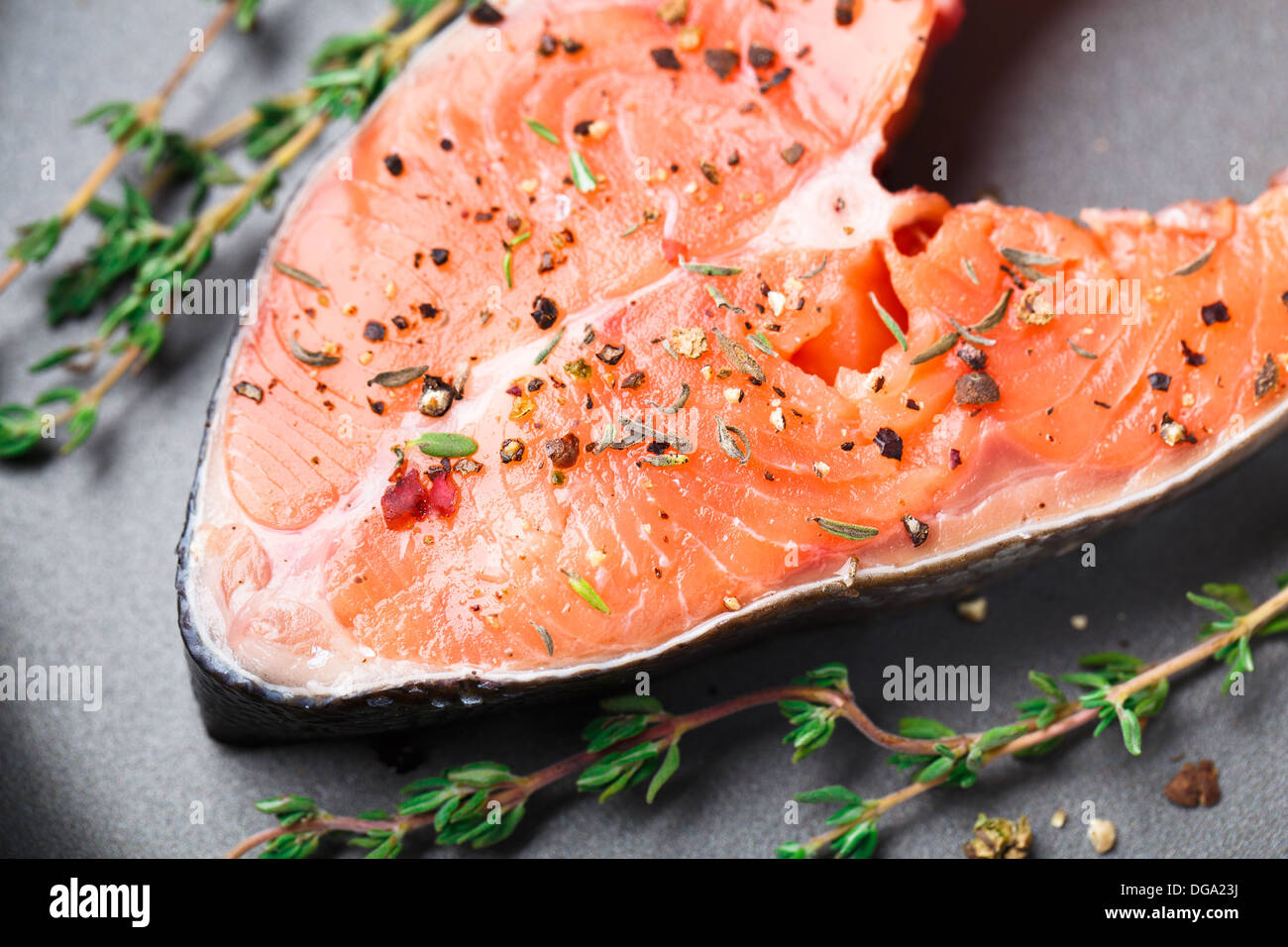 Salmon steak with thyme and pepper Stock Photo Alamy