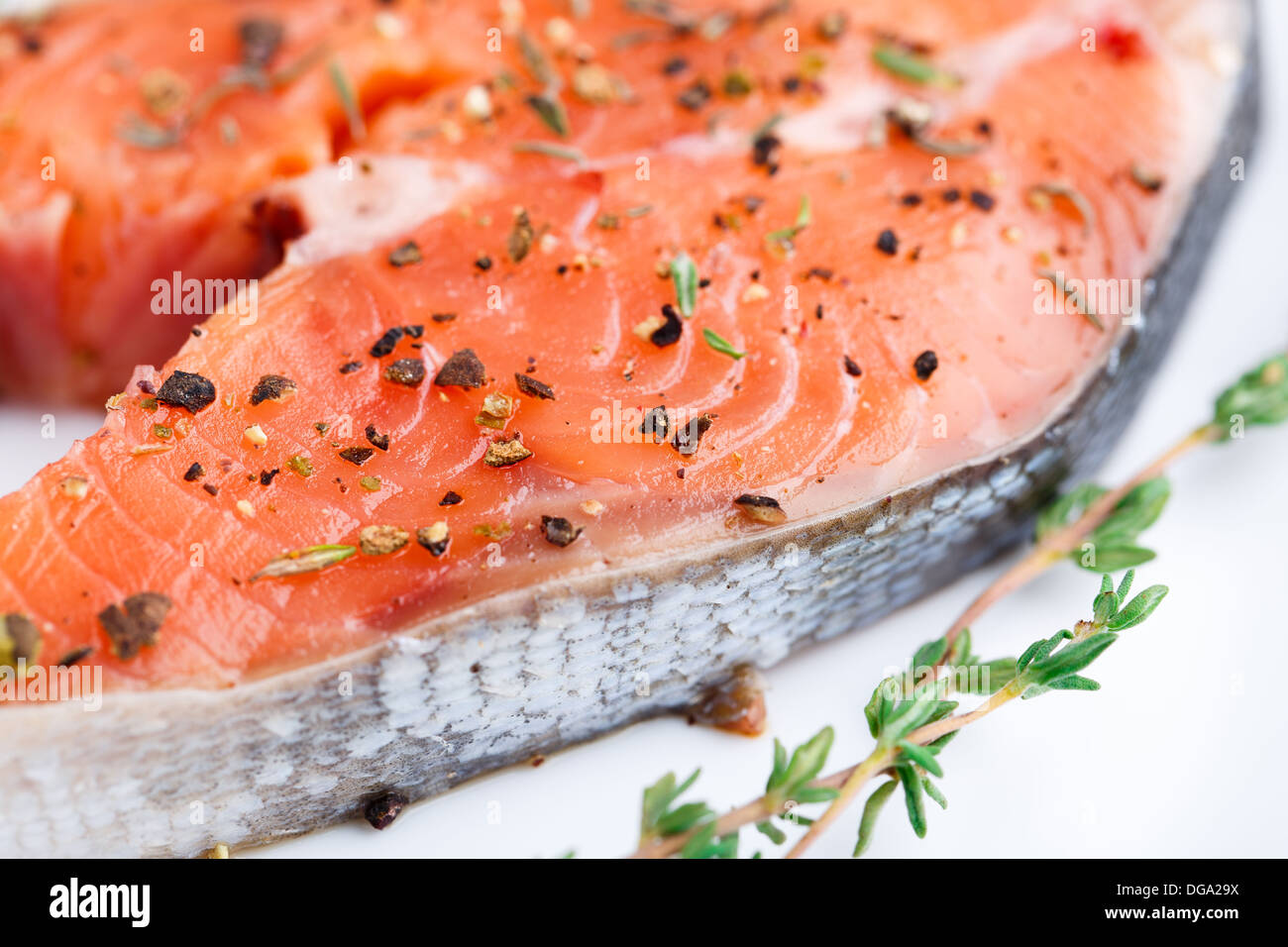Salmon steak with thyme and pepper Stock Photo Alamy