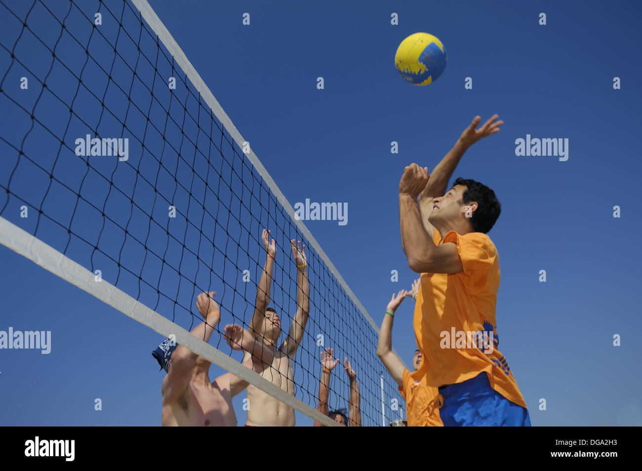 Boys playing beach volleyball Stock Photo Alamy
