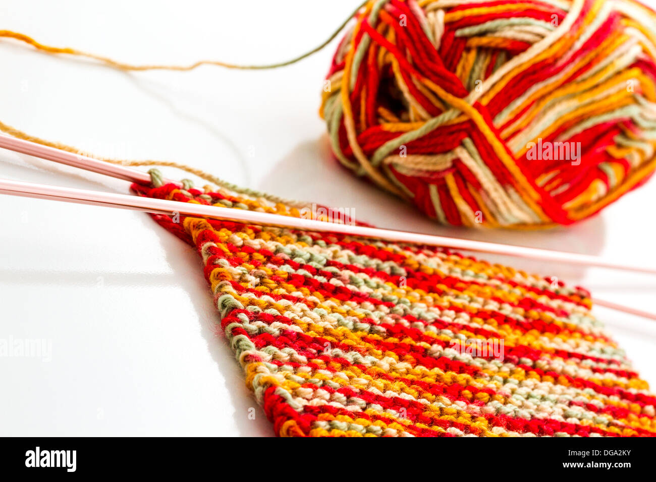 Knitting with multi colored yarn with orange, red, and yellow tones Stock  Photo - Alamy