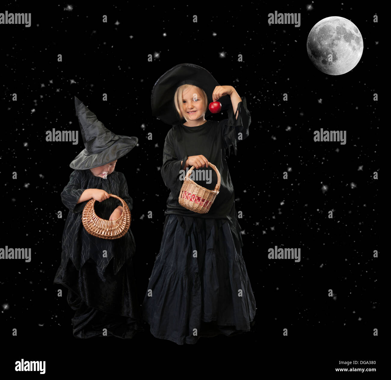 two little halloween witches, background with stars and moon Stock Photo