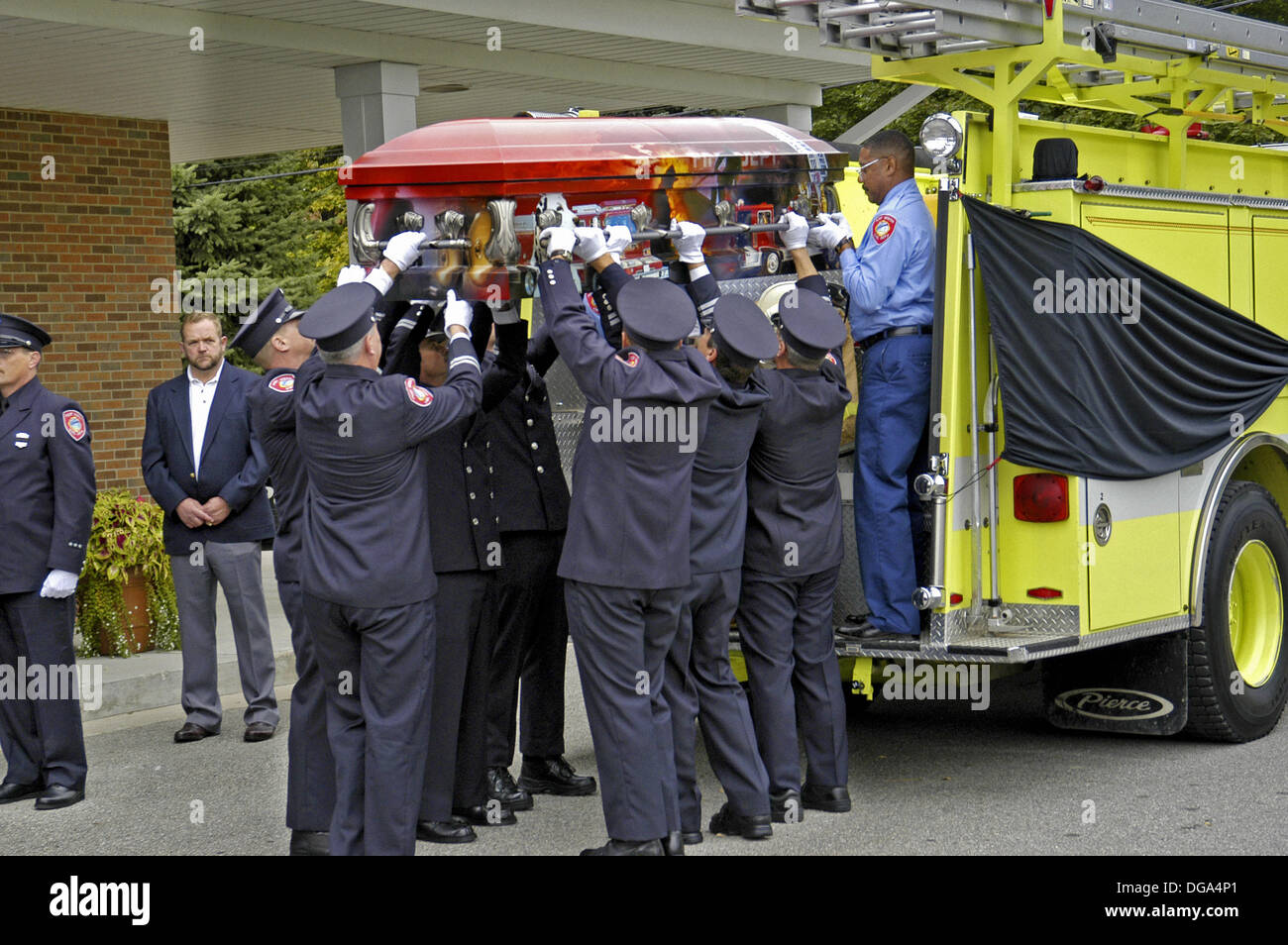 Funeral procession for a fire chief a fire engine acted as hearse and