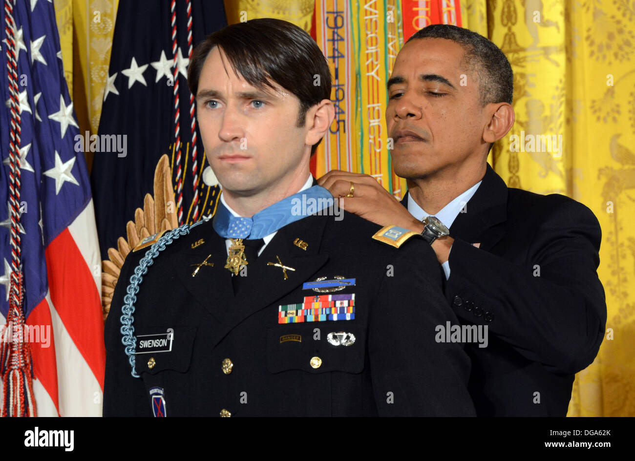 US President Barack Obama presents former Army Capt. William D. Swenson with the Medal of Honor during a ceremony in the East Room of the White House October 15, 2013 in Washington, DC. The Medal of Honor is the nation's highest military honor. Stock Photo