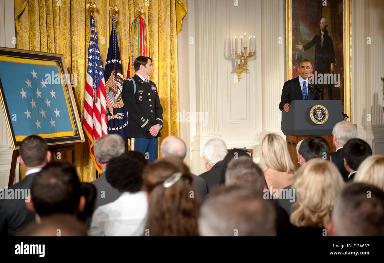 US President Barack Obama gives remarks during the Medal of Honor ceremony for former US Army Capt. William D. Swenson in the East Room of the White House October 15, 2013 in Washington, DC. The Medal of Honor is the nation's highest military honor. Stock Photo