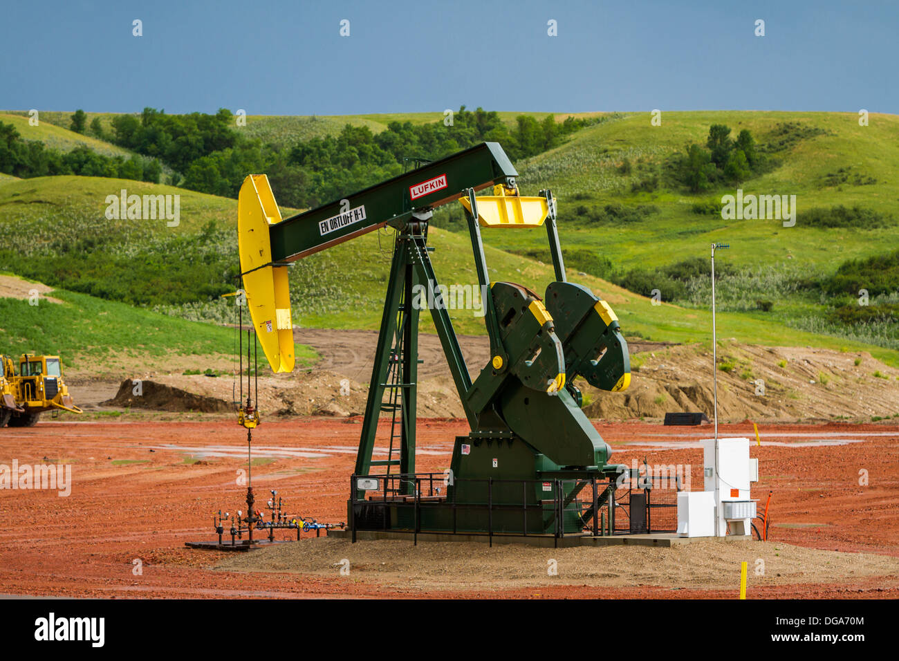 Oil pumpers in the Bakken play shale oil fields in the rolling hills ...