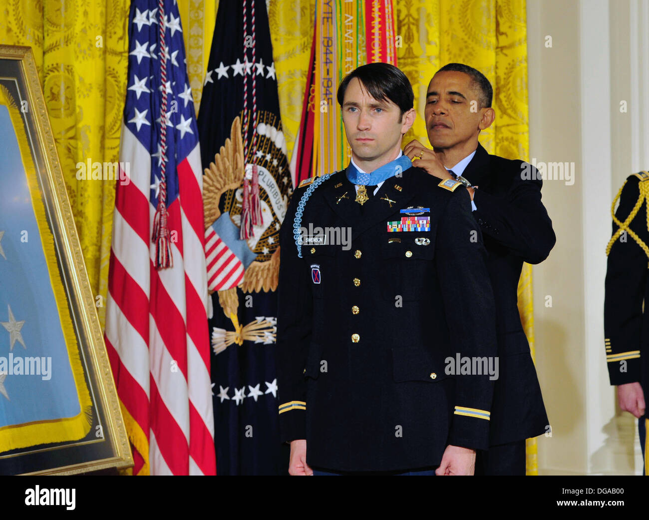US President Barack Obama presents former US Army Capt. William D. Swenson with the Medal of Honor during a ceremony in the East Room of the White House October 15, 2013 in Washington, DC. The Medal of Honor is the nation's highest military honor. Stock Photo