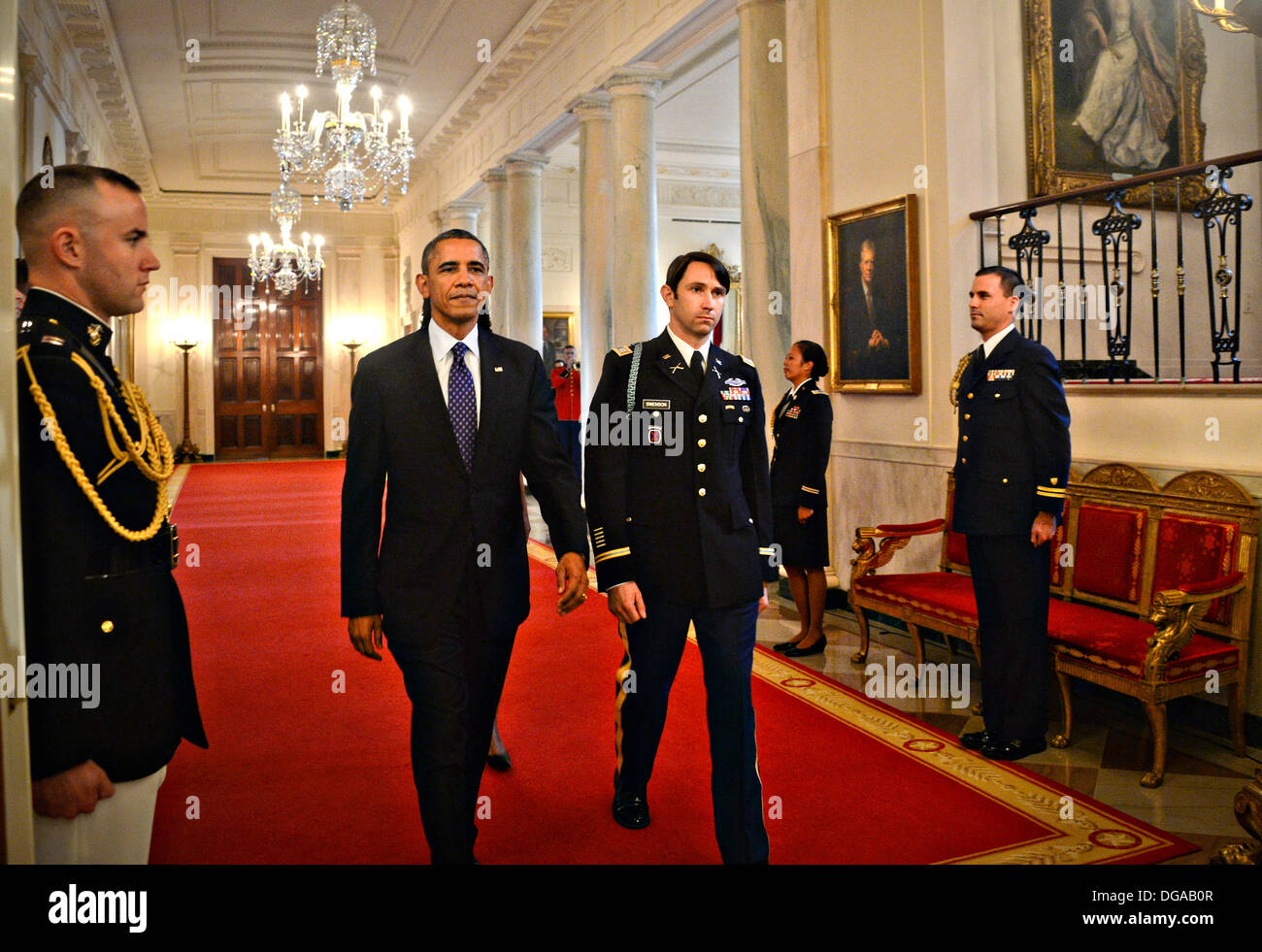 US President Barack Obama escorts Former US Army Capt. William D. Swenson to the East Room of the White House where he will be presented the Medal of Honor October 15, 2013 in Washington, DC. The Medal of Honor is the nation's highest military honor. Stock Photo