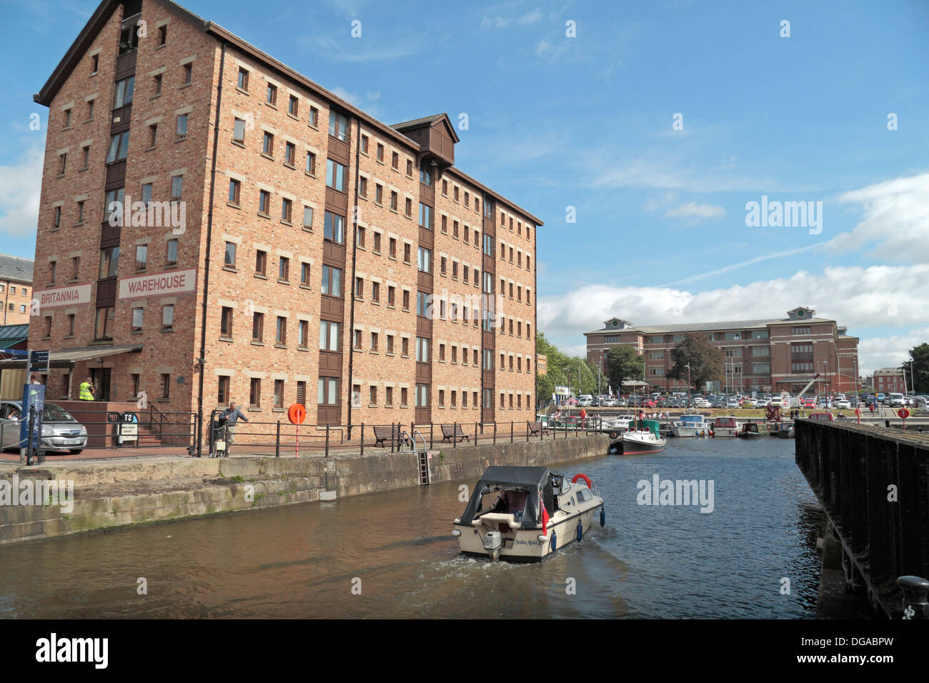 A small cruiser entering Victoria Dock in Gloucester docks, Gloucestershire, UK Stock Photo