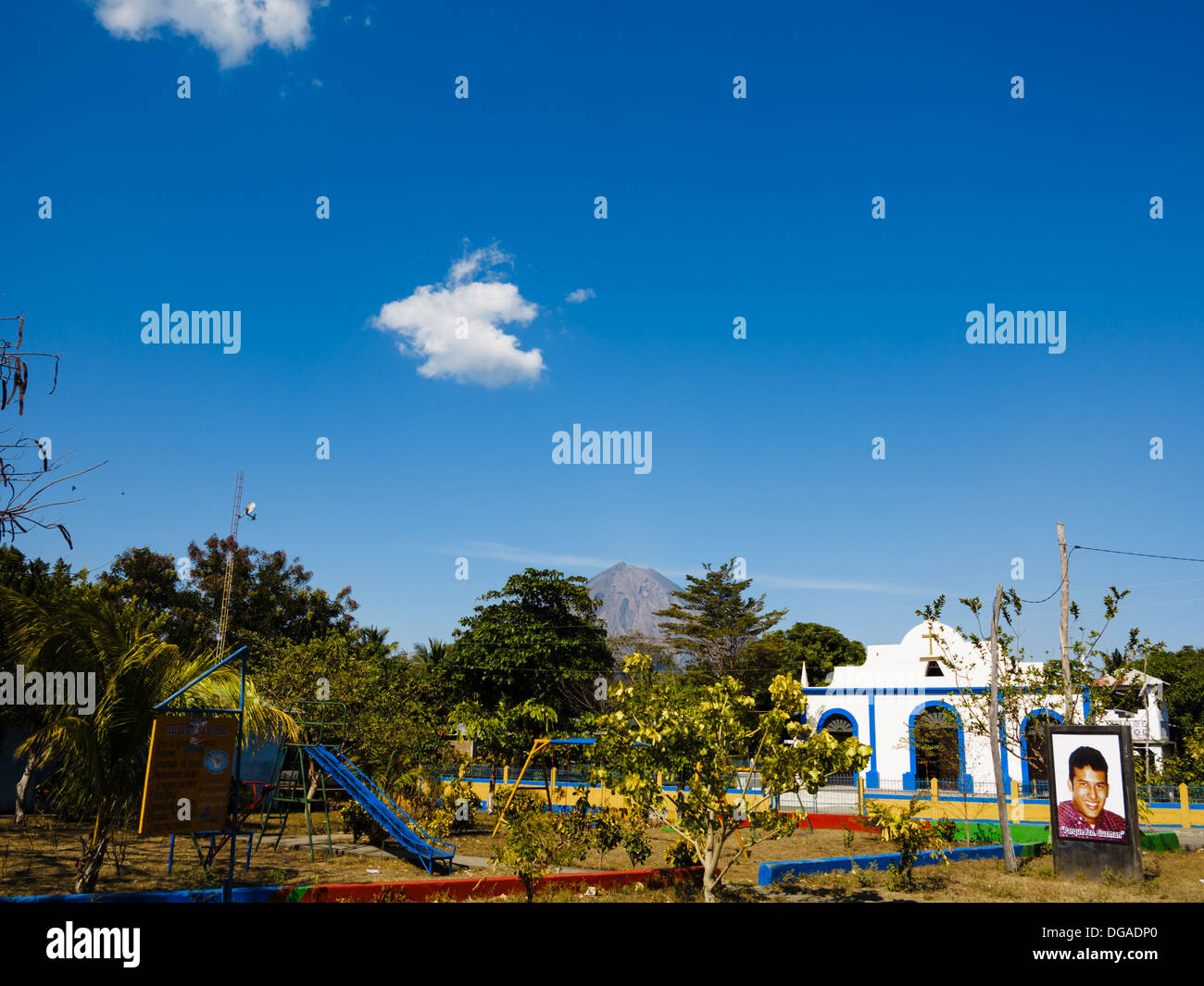 playground near church on Ometepe Island Nicaragua view of active Conception volcano rising in the background a few miles away Stock Photo